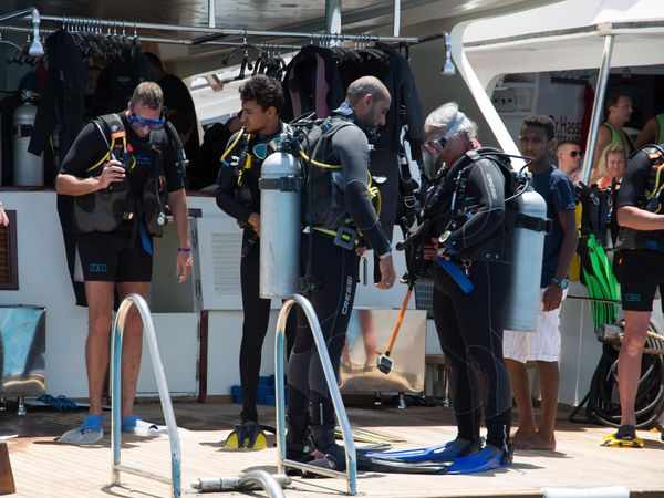 Red sea divers doing buddy check and getting ready to dive from Dive-Hurghada boat